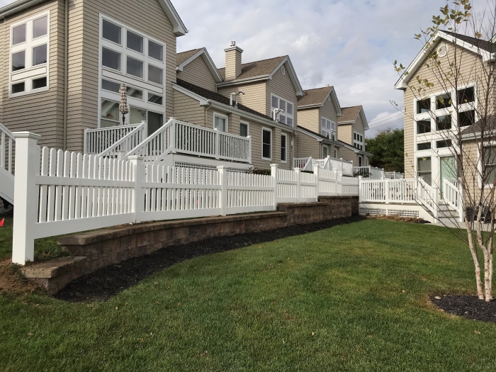 PVC Stepped Picket Fence on Retaining Wall