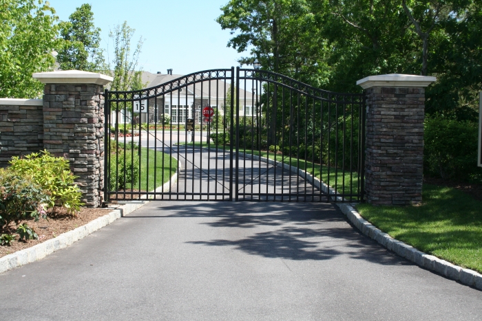 Automated Arched Ornamental Steel Double Gate Hung Between Columns